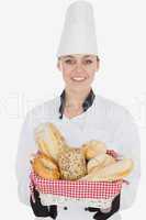 Happy young chef holding bread basket