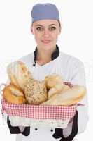 Chef with fresh breads in basket