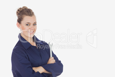 Young female technician holding wrench