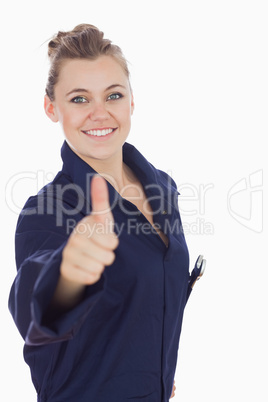 Female mechanic showing thumbs up