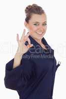 Happy female technician showing ok sign