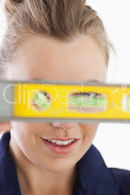 Young female technician with spirit level