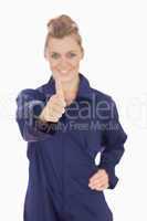 Young female technician gesturing thumbs up