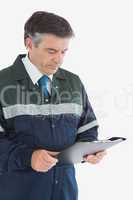 Repairman reading notes on clipboard