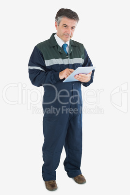 Portrait of repairman holding digital tablet