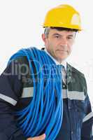 Mature man wearing hardhat with cable