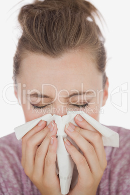 Woman blowing nose