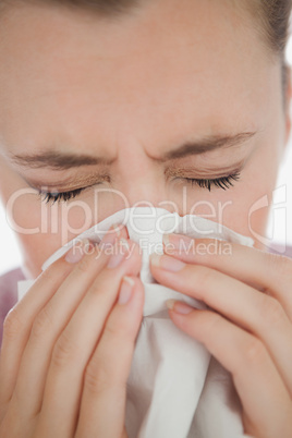 Woman blowing her nose