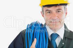 Repairman with rolled wire wearing hardhat