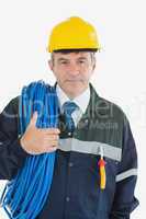 Confident male repairman with rolled wire and hardhat