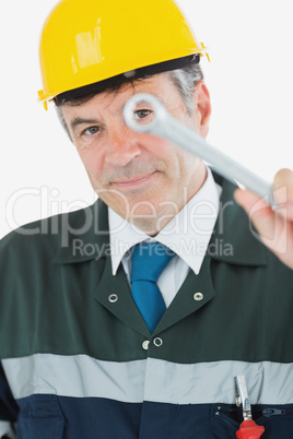 Mature repairman holding wrench