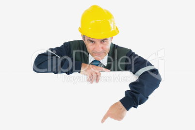 Confident repairman pointing at billboard