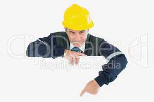 Confident repairman pointing at billboard