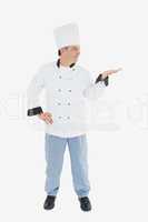 Mature chef looking at invisible product