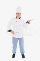 Mature chef presenting invisible product