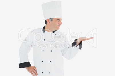 Male chef looking at invisible product
