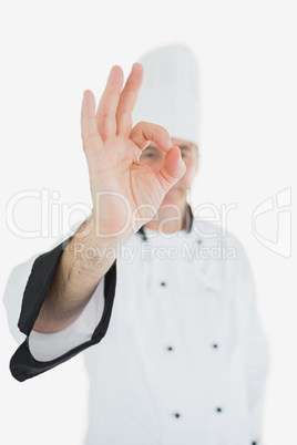 Mature chef in uniform showing ok sign