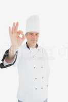 Mature male chef showing ok sign