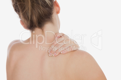Topless woman massaging back