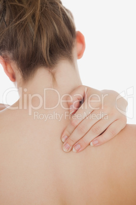 Close-up of topless woman massaging back
