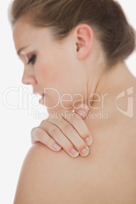 Upset woman suffering from shoulder pain