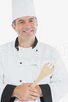 Happy mature chef holding spatula