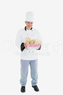 Male chef holding bread basket