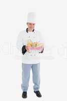 Male chef holding bread basket