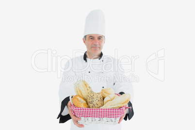 Male chef with fresh breads in basket