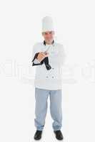 Happy chef holding wire whisk