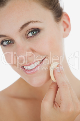Close-up of woman applying makeup