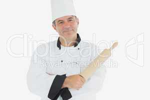 Mature chef holding rolling pin