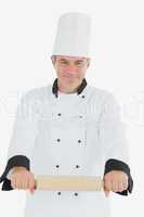 Male chef using rolling pin