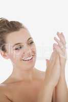 Woman applying moisturizer on hands