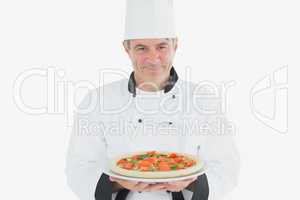 Male chef holding pizza