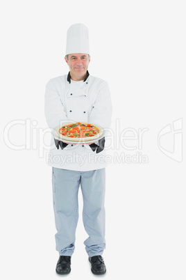 Chef holding pizza