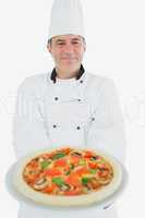 Happy chef offering pizza