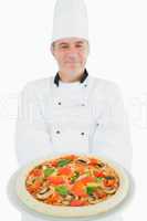 Chef holding delicious pizza