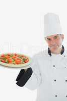 Happy chef holding pizza