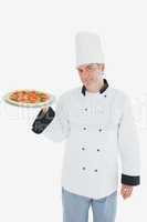 Confident male chef with pizza