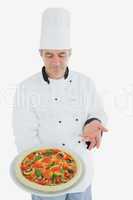 Male chef holding pizza