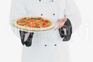 Chef offering pizza