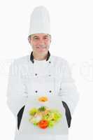 Male chef displaying fresh meal