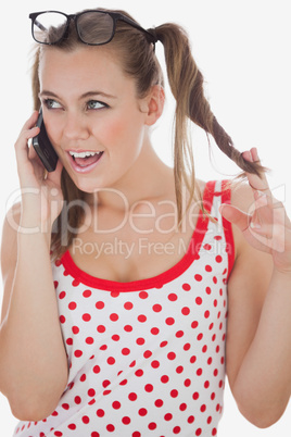 Young woman on call playing with hair
