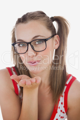 Portrait of young woman blowing air kiss