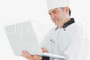 Chef using laptop smiling