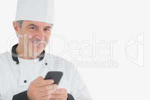 Male chef holding cell phone