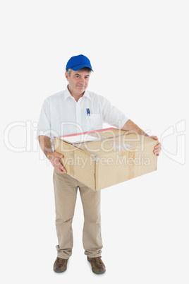 Courier man carrying cardboard box