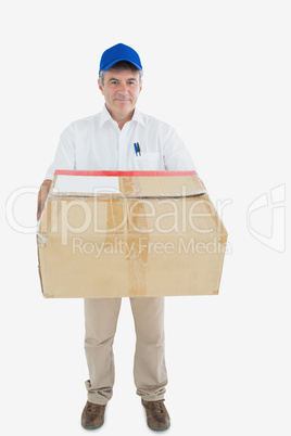 Mature courier man carrying package