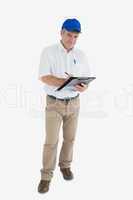 Portrait of mature delivery man writing on clipboard